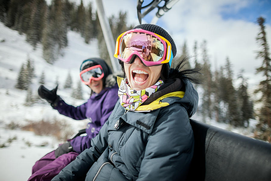 Girls laughing and having fun on a chair lift. Photograph by Daniel Milchev