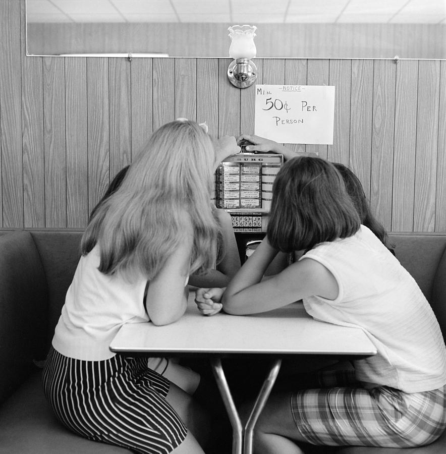Girls Operating Small Juke Box, C.1960s Photograph by H. Armstrong Roberts/ClassicStock