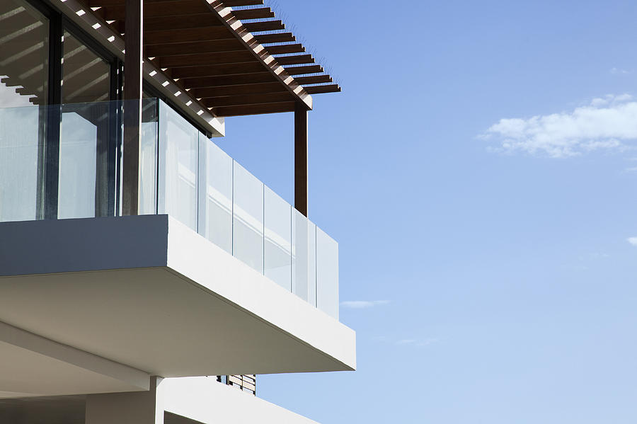 Glass balcony on modern house Photograph by Martin Barraud