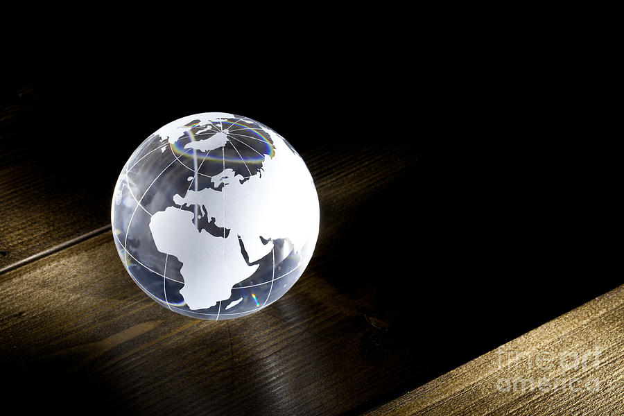 Globe Photograph - Glass globe on wooden floor by Simon Bratt