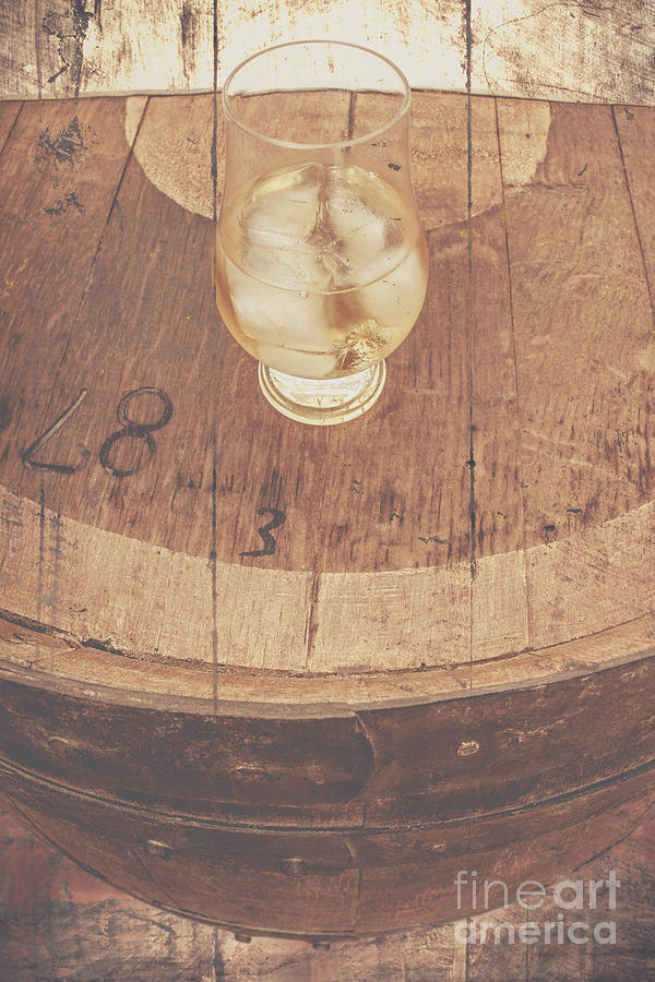 Glass of cellar brandy on old barrel  Photograph by Jorgo Photography