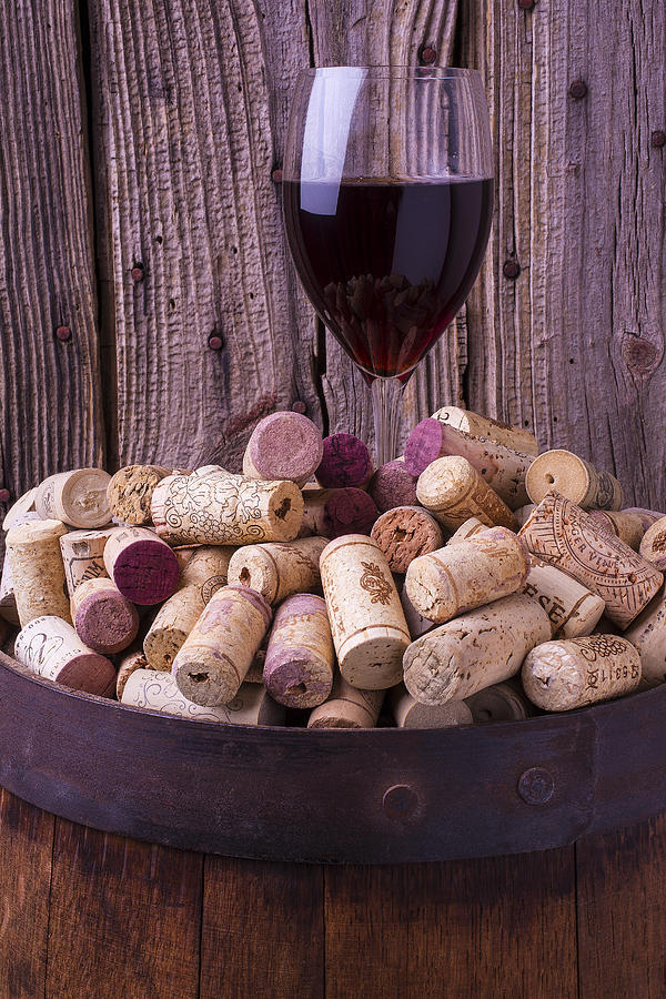 Glass Of Wine With Corks Photograph by Garry Gay