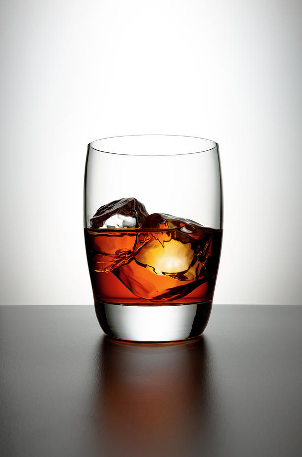 Glass With Brown Liquor And Ice Cubes Photograph by Chris Stein