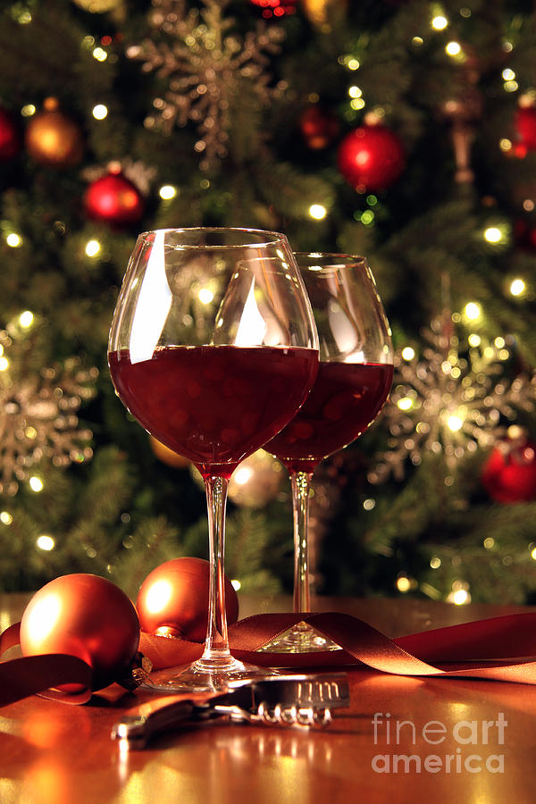 Glasses of wine in front of Christmas tree Photograph by Sandra Cunningham