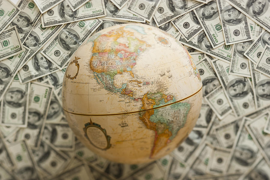 Globe on US dollars background Photograph by Mike Kemp