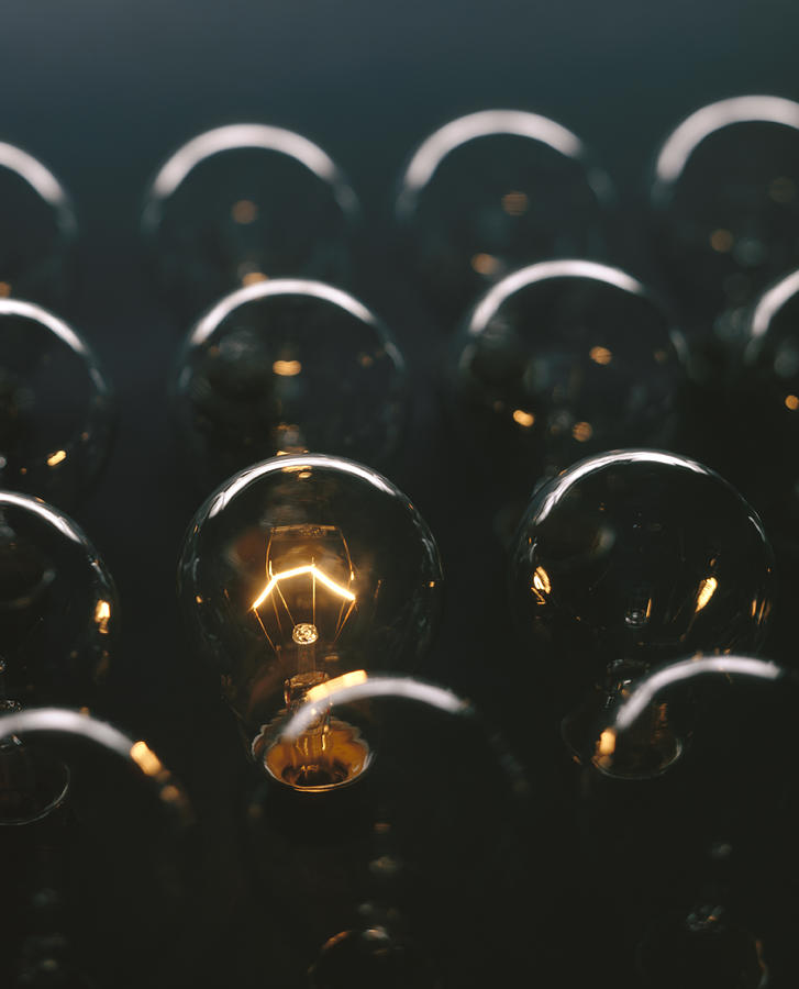 Glowing light bulb against dark background Photograph by Patrick Llewelyn-Davies Glowing light bulb against dark background Photograph by Patrick Llewelyn-Davies