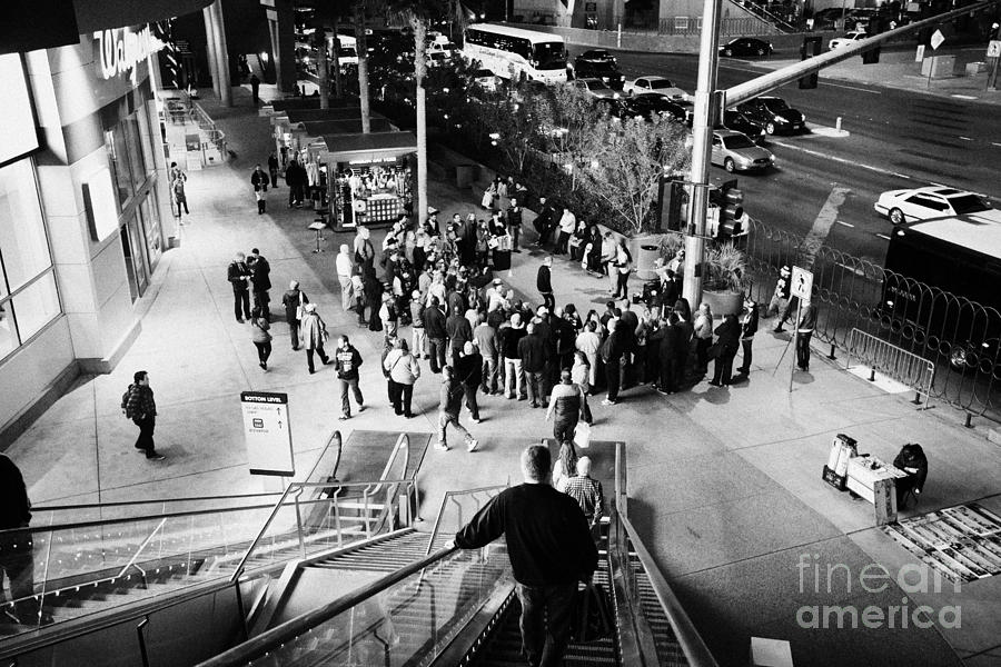 Las Vegas Photograph - Going Down Escalator To Crowd Around Street Entertainer At Night Las Vegas Boulevard Nevada Usa by Joe Fox