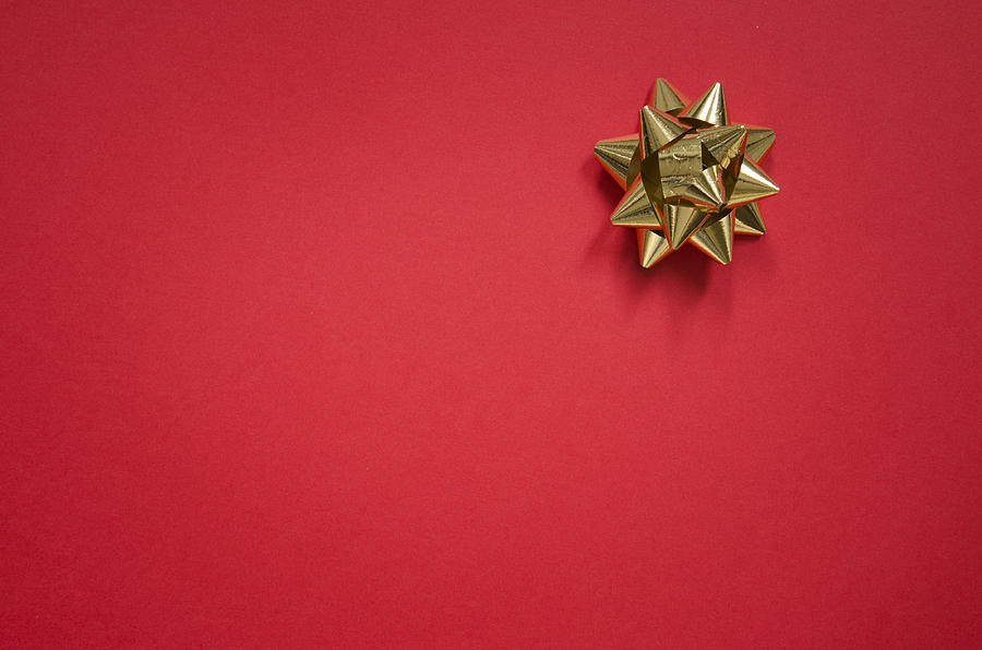 Gold bow on christmas red background Photograph by Franckreporter