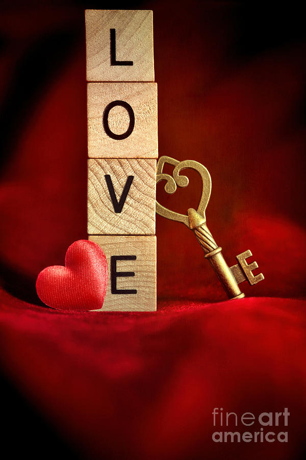 Gold key with wooden block letters that spell the word love Photograph by Sandra Cunningham