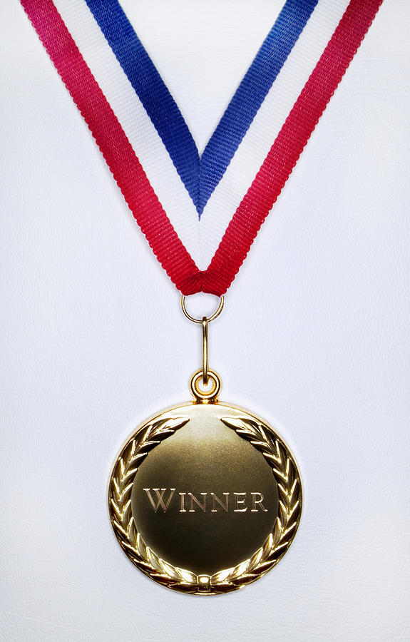 Gold Medal on a White Background Engraved With the Single Word Winner Photograph by Harrison Eastwood