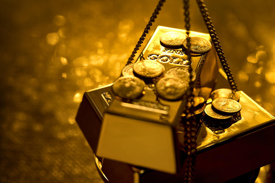 Gold on weight scale Photograph by GM Stock Films