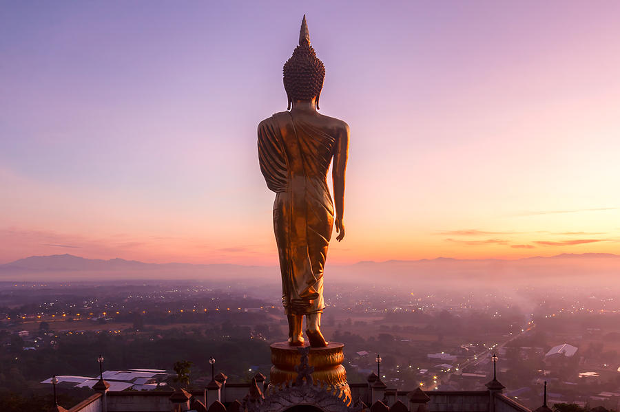 Golden buddha statue in Khao Noi temple at sunrise time, Nan Province, Thailand Photograph by Pakin Songmor