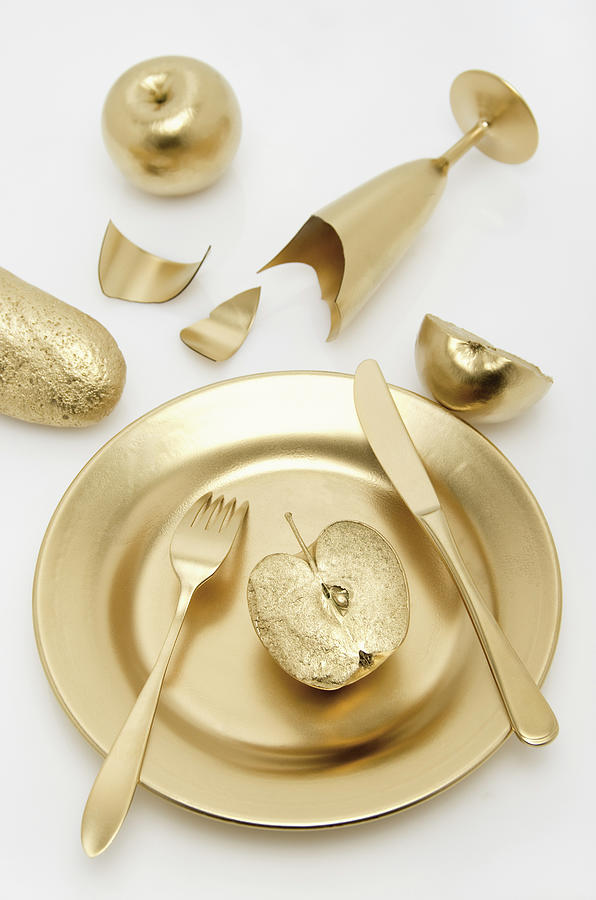 Golden Cutlery With Apple And Bread On Photograph by Westend61