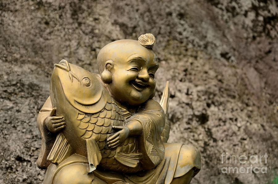 Golden laughing monk with fish Photograph by Imran Ahmed