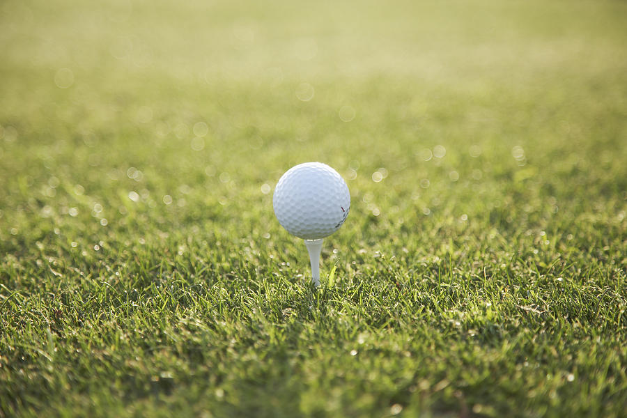 Golf ball on tee Photograph by Brick House Pictures