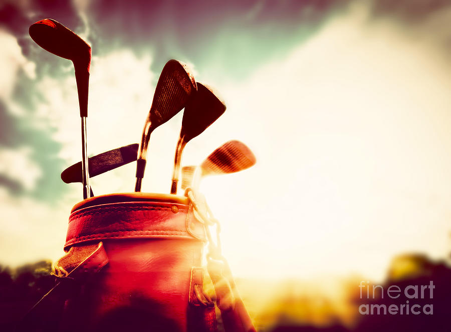 Golf Photograph - Golf clubs in a leather baggage in vintage retro style at sunset by Michal Bednarek