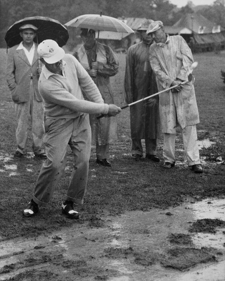 Black And White Photograph - Golfer Playing In The Rain by Underwood Archives