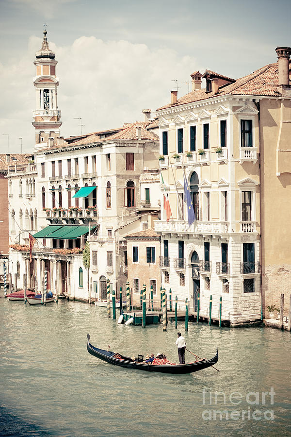 Gondola on the grand canal by Rialto Bridge in Venice Italy by Raimond Klavins Photograph by Raimond Klavins
