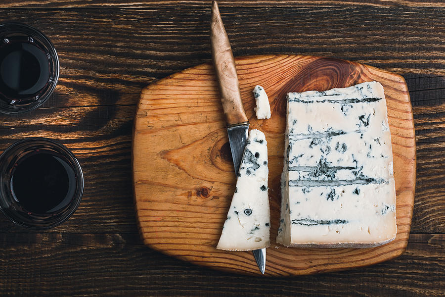 Gorgonzola cheese on wooden cutting board Photograph by Istetiana