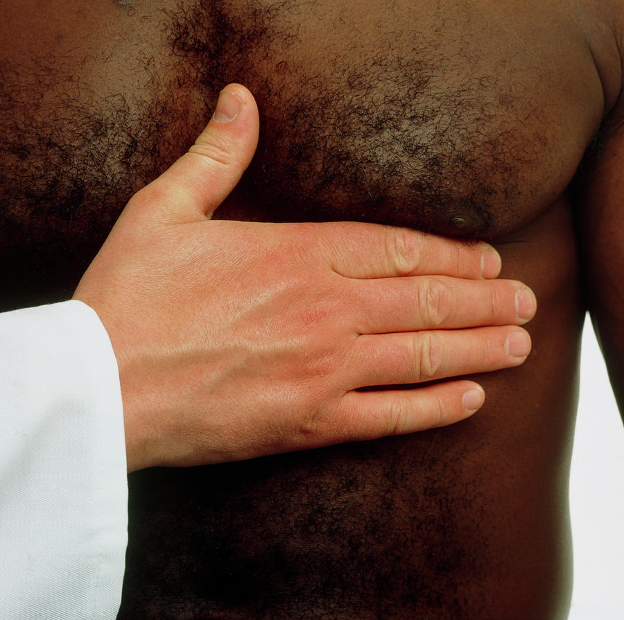Gp Feeling Mans Chest For His Heartbeat Photograph by Saturn Stills/science Photo Library