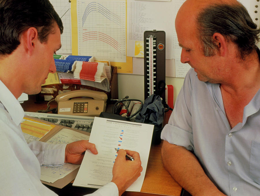 Gp Showing Patient A Low-cholesterol Diet Plan Photograph by Science Photo Library Gp Showing Patient A Low-cholesterol Diet Plan Photograph by Science Photo Library