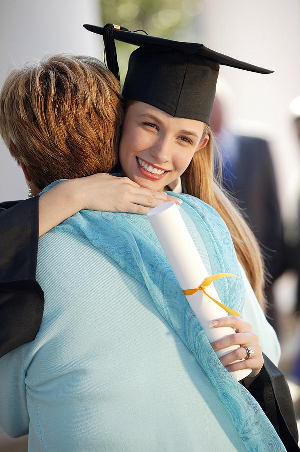 Graduate with mother Photograph by Comstock Images