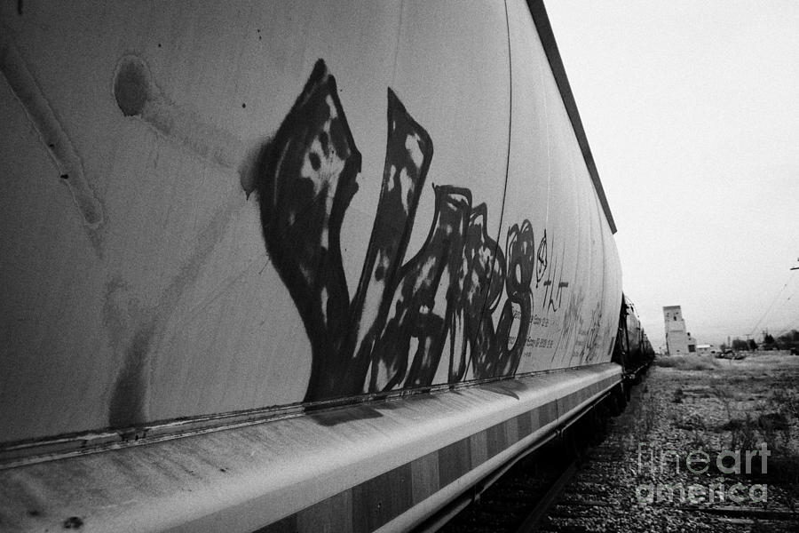 Truck Photograph - graffiti on freight grain trucks on canadian pacific railway through assiniboia Saskatchewan Canada by Joe Fox