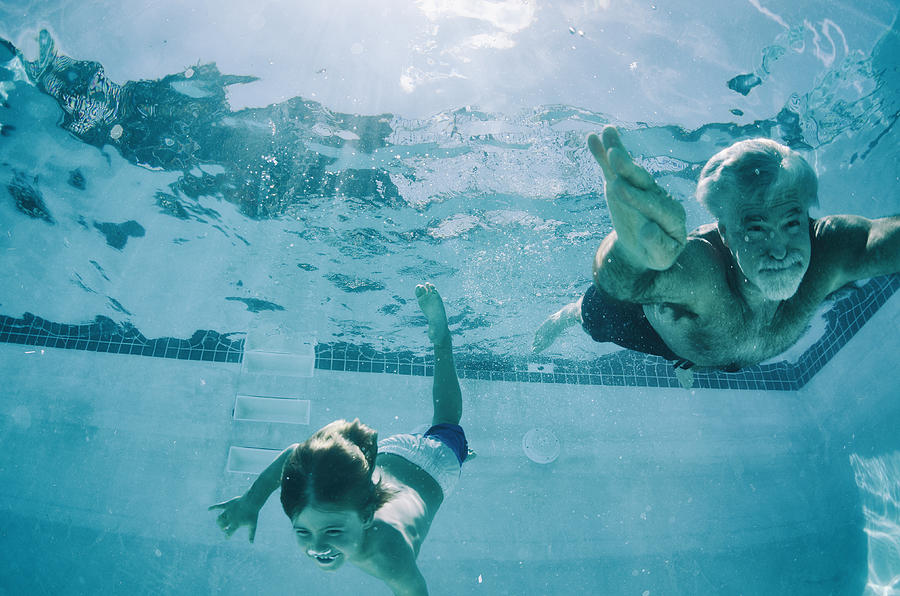 Grandpa and Grandson swimming underwater in summer Photograph by AshleyWiley