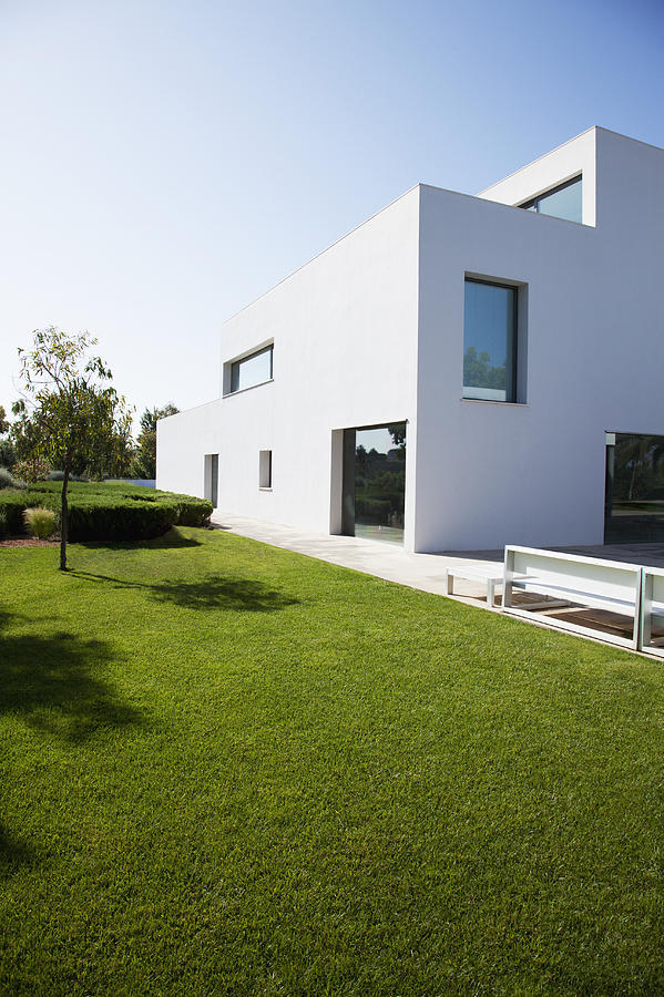 Grassy lawn of modern house Photograph by Martin Barraud