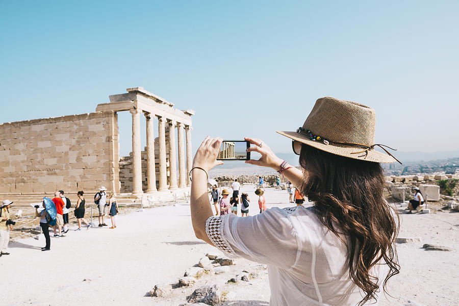 Greece, Athens, woman taking a cell phone picture of the Erechtheion temple in the Acropolis Photograph by Westend61