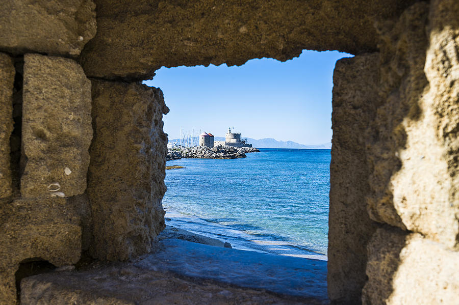 Greece, Rhodes, View through a window at the coast to the okld town Photograph by Westend61