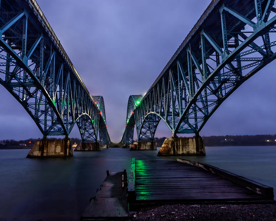 Bridge Photograph - Green Light on the pier below Twin spans on a misty dawn by Chris Bordeleau