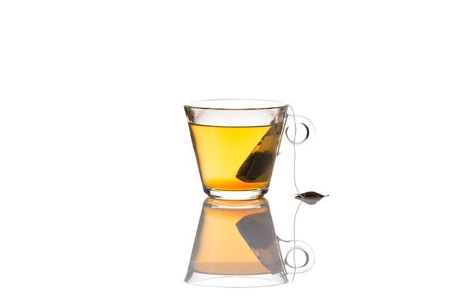 Green tea glass cup with bag, isolated on white background Photograph by R.Tsubin