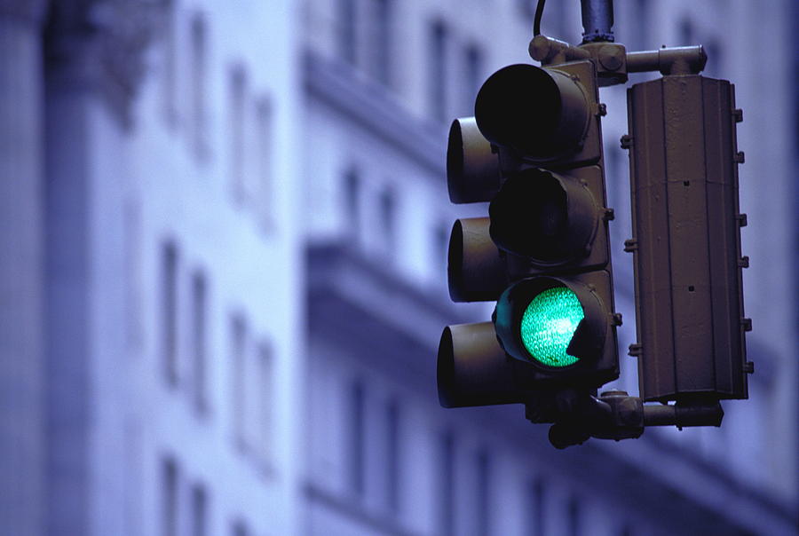 Green traffic light, low angle view Photograph by Martin Barraud