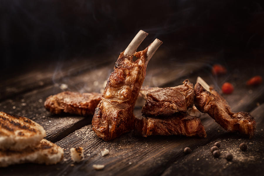 Grilled lamb chops on wooden table Photograph by Da-kuk