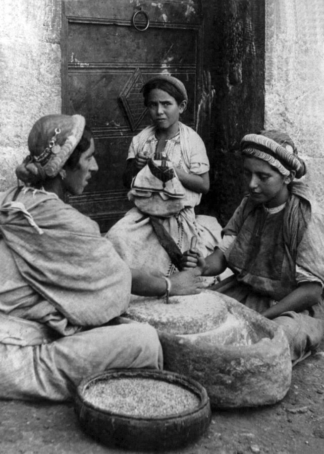 Vintage Photograph - Grinding Wheat in Palestine by Munir Alawi