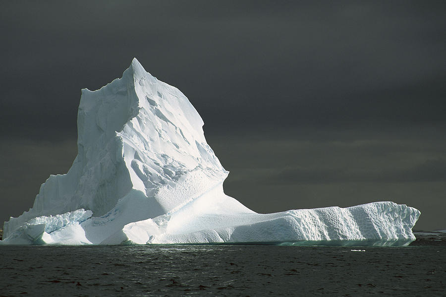 Grounded Iceberg With Storm Clouds Photograph by Colin Monteath