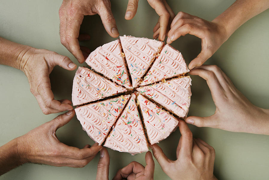 Group of eight people reaching for slice of cake, close-up, overhead view Photograph by David Malan