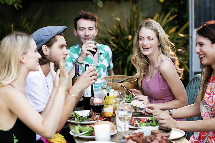 Outdoors Photograph - Group Of Friends Eating Lunch Outdoors by Science Photo Library