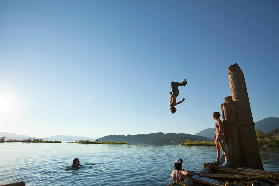 Group Of Friends Swimming And Jumping Photograph By Woods Wheatcroft ...