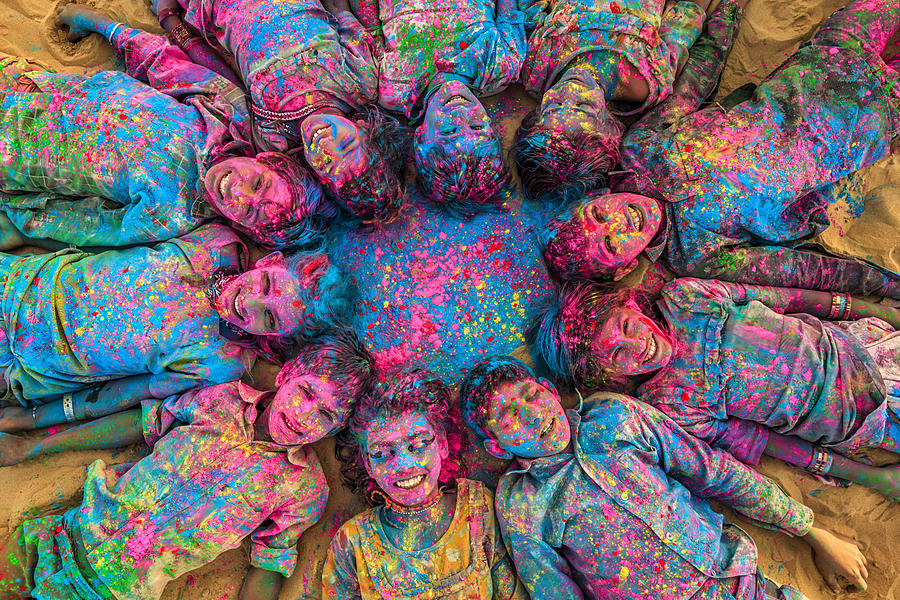 Group of happy Indian children playing holi, desert village, India Photograph by Hadynyah