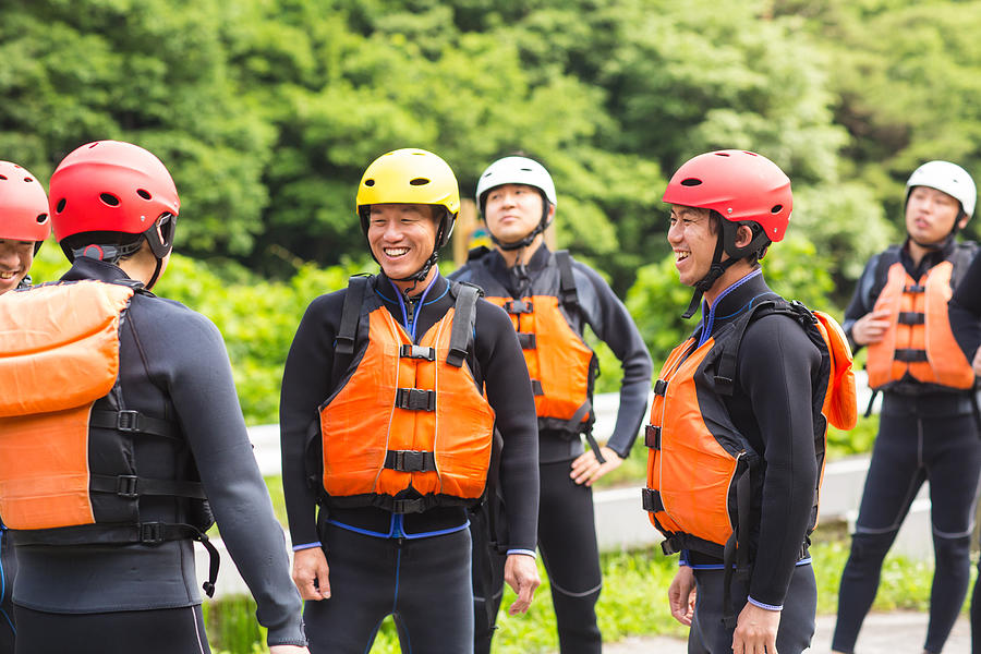 Group of men wearing life jackets and helmets before a river rafting tour Photograph by Tdub303