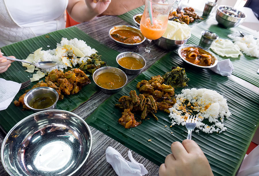 Group of People Eating Sadya or Banana Leaf Rice Indian Food. Photograph by Nora Carol Photography