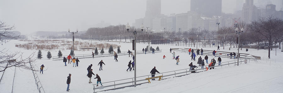 Architecture Photograph - Group Of People Ice Skating In A Park by Panoramic Images