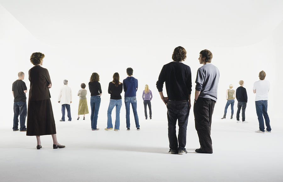 Group of people standing in studio, rear view Photograph by Martin Barraud