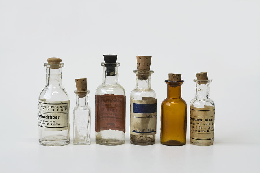 Group of small vintage translucent medicine bottles. Photograph by Ekely