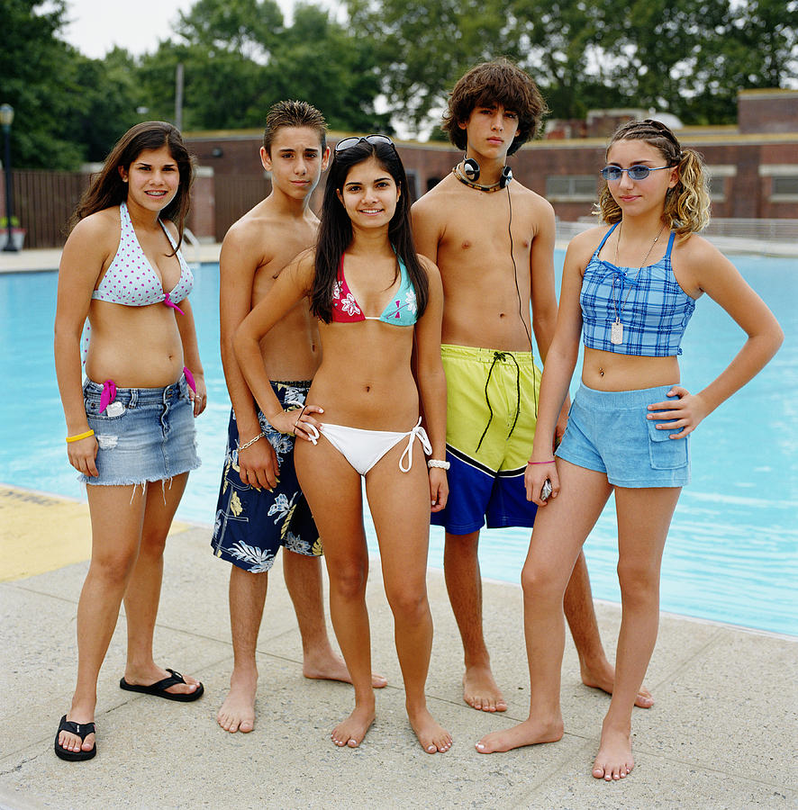 Group of teenagers (13-16) near pool, portrait Photograph by Sean Justice