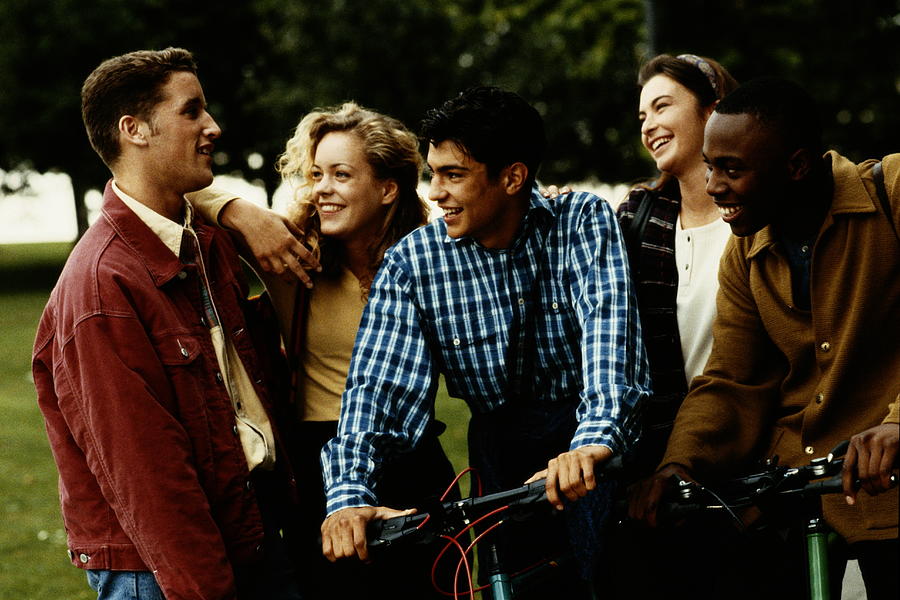 Group of teenagers (16-18)  talking in park Photograph by Getty Images