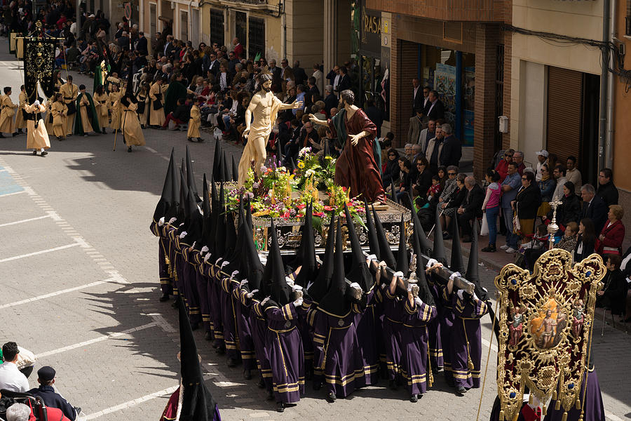 Grupo de mujeres nazarenas anderas llevando un trono a hombros, en la Semana Santa de Jumilla. Photograph by Juanma Domínguez