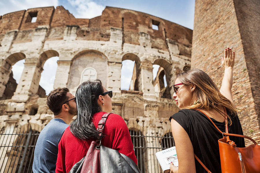 Guide explaining to tourists the Coliseum of Rome Photograph by Piola666